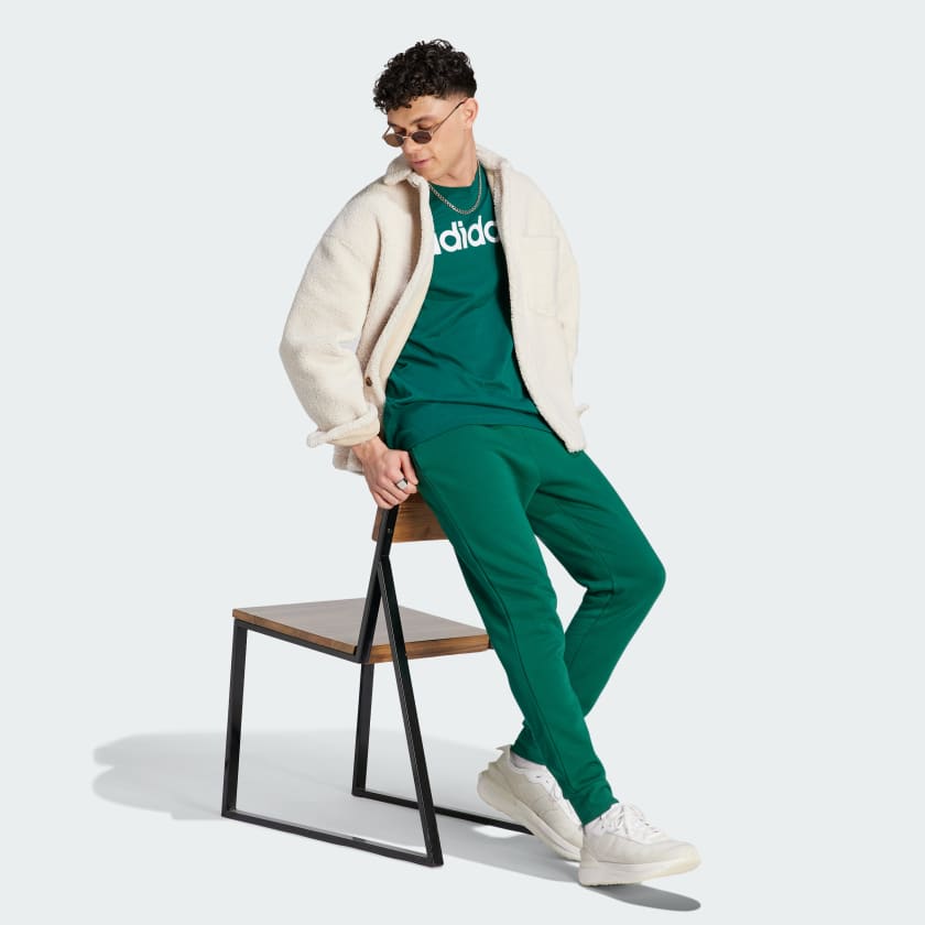 شلوار سبز رنگ آدیداس مدل ESSENTIALS FLEECE REGULAR TAPERED JOGGERS